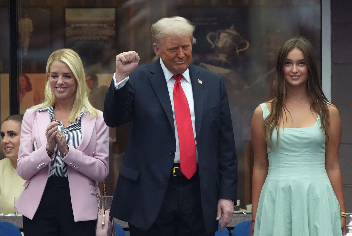 NEW YORK, NEW YORK - SEPTEMBER 07: U.S. President Donald Trump pumps his as U.S. Attorney General Pam Bondi (L) and Arabella Kushner (R) look on before the start of the U.S. Open men's singles final at the Billie Jean King National Tennis Center for the U.S. Open finals on September 7, 2025 in New York City. President Trump is attending the U.S. Open menâs singles final between Carlos Alcaraz and Jannik Sinner. (Photo by Kevin Dietsch/Getty Images)