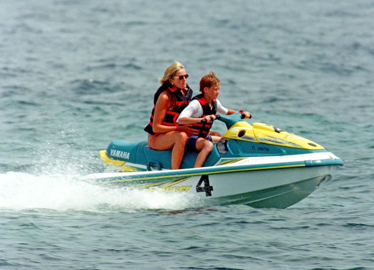Prince Harry takes the wheel of a jet ski with Princess Diana during a sun-soaked family vacation in St. Tropez, France, capturing another adventurous moment between mother and son.