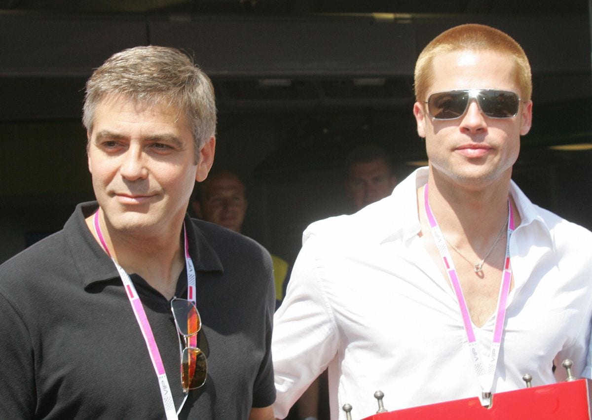George Clooney abd  Brad Pitt pose in the pits of the Monte-Carlo racetrack May 2004