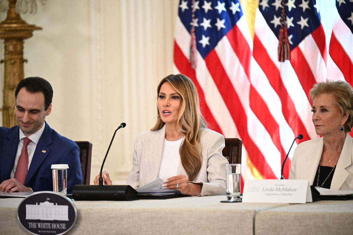 Earlier in the day, Melania attended a White House Task Force meeting on AI Education, where she wore a two-piece pinstripe power suit 