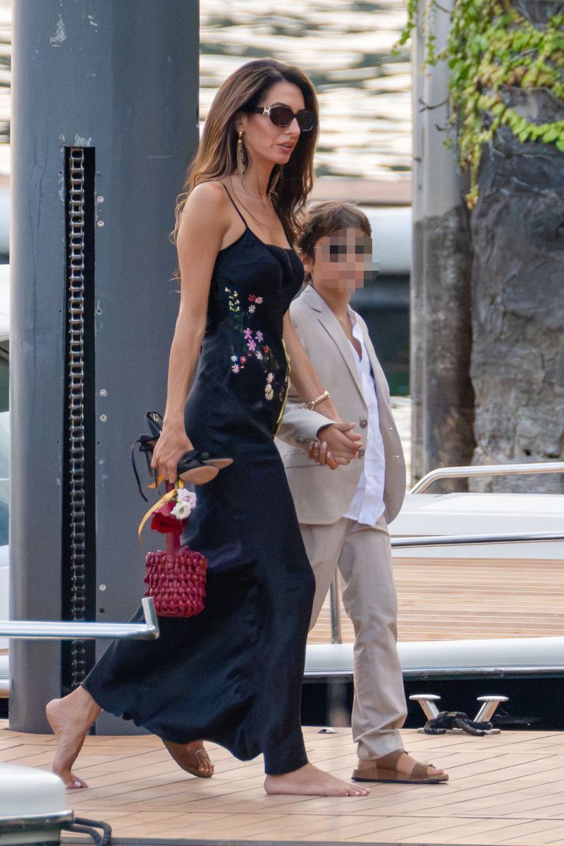 Amal Clooney looked effortlessly elegant in a black embroidered dress as she attended the family's charity gala in Lake Como.