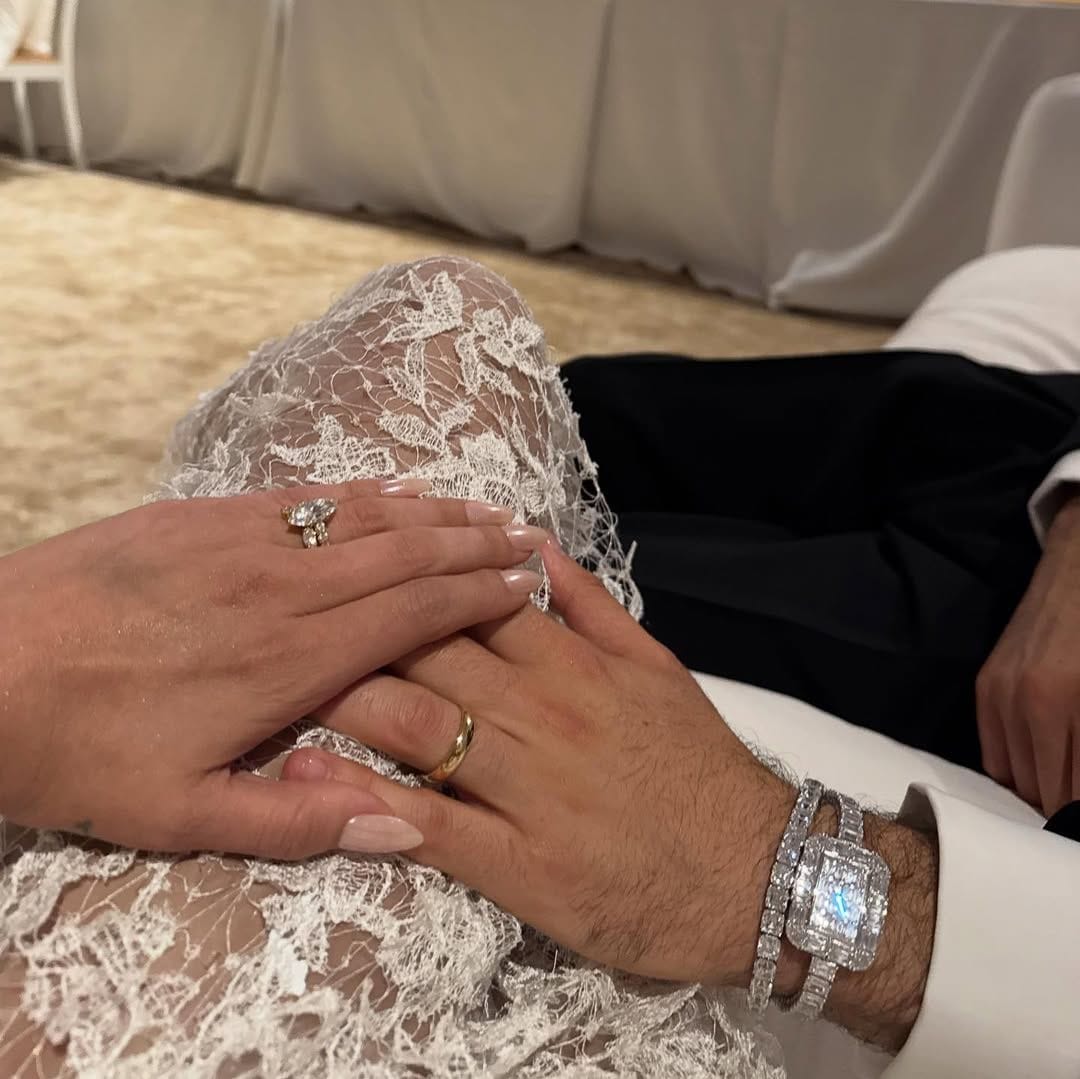 Benny wore a matching gold band, accessorized with a diamond-covered watch and bracelet