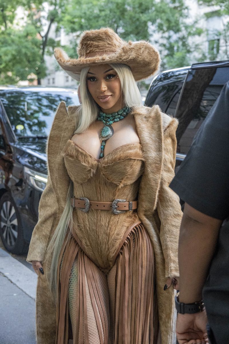 Cardi B turned heads in Paris with a daring cowboy-inspired outfit as she made her way to Beyoncé's highly anticipated concert. 