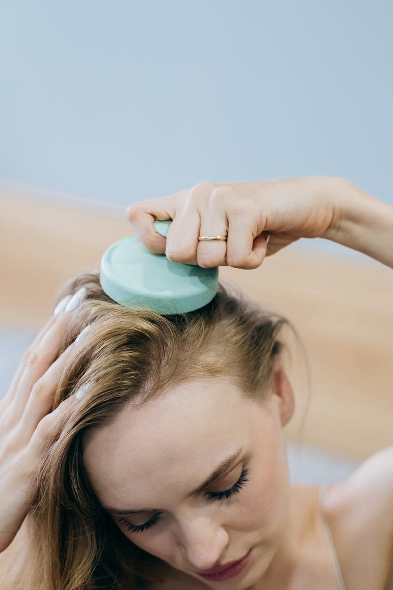 Head massage equipment on wooden surface. Massager for head and body relaxing. Stainless steel octopus scalp hair stress relief head massager. Headache and migraine. Home use Acupuncture Point. 