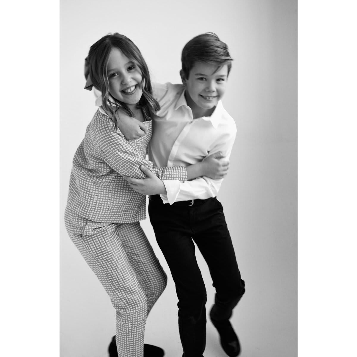 Say cheese! The twins showed off their playful side, hugging each other during their birthday photo session.