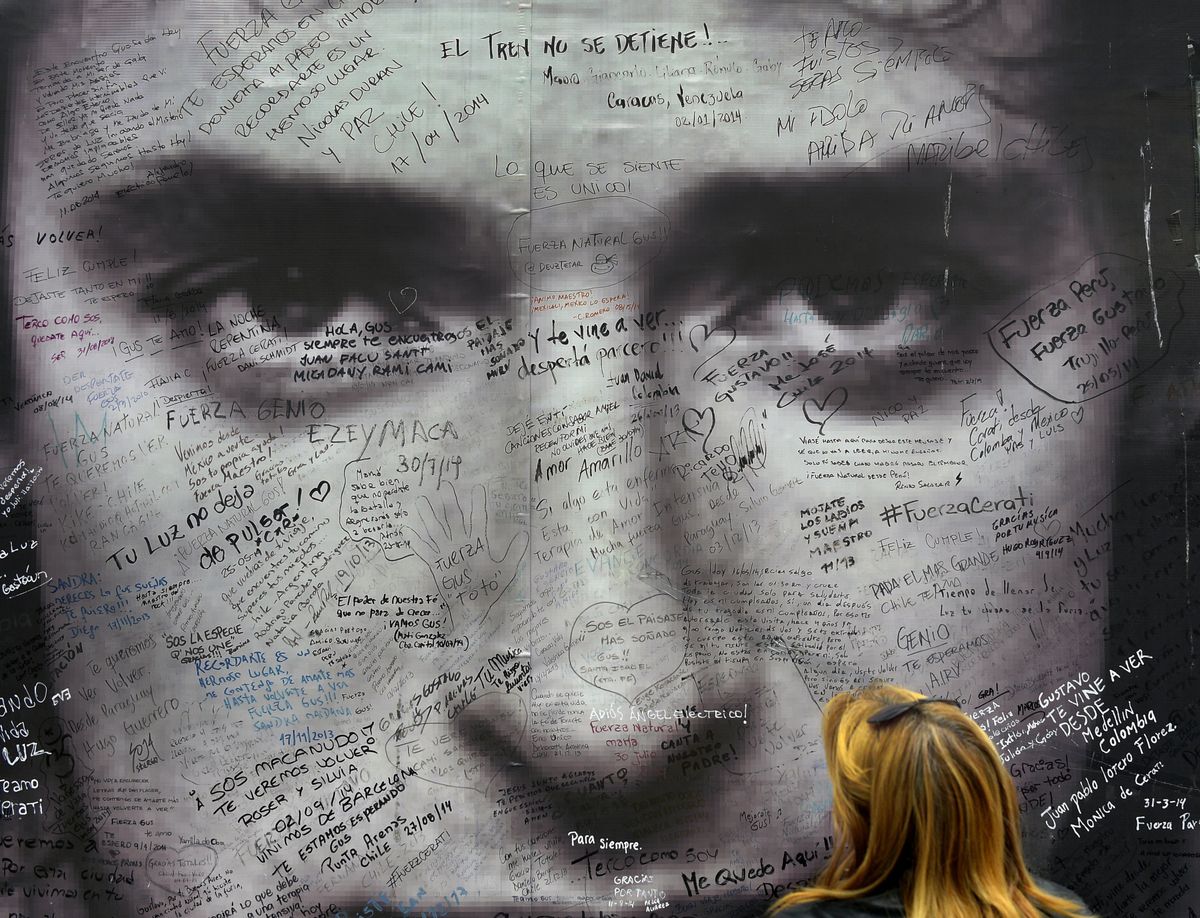 A fan watches a poster of Argentine artist Gustavo Cerati in front of the clinic where the musician died from a stroke on September 4, 2014, in Buenos Aires. On May 15, 2010, Cerati suffered a stroke due to a decompensation after a performance in Caracas, Venezuela. Cerati was an Argentine singer-songwriter, composer, and producer, one of the most important and influential figures of Ibero-American rock.