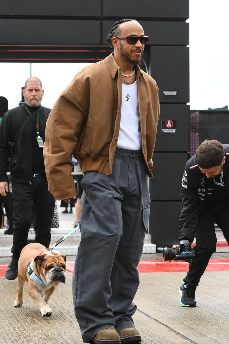Lewis Hamilton of Great Britain and Mercedes-AMG Petronas F1 is posing with Roscoe during the Formula 1 Qatar Airways British Grand Prix at the Silverstone Circuit in Towcester, England, on Friday, July 5, 2024. 