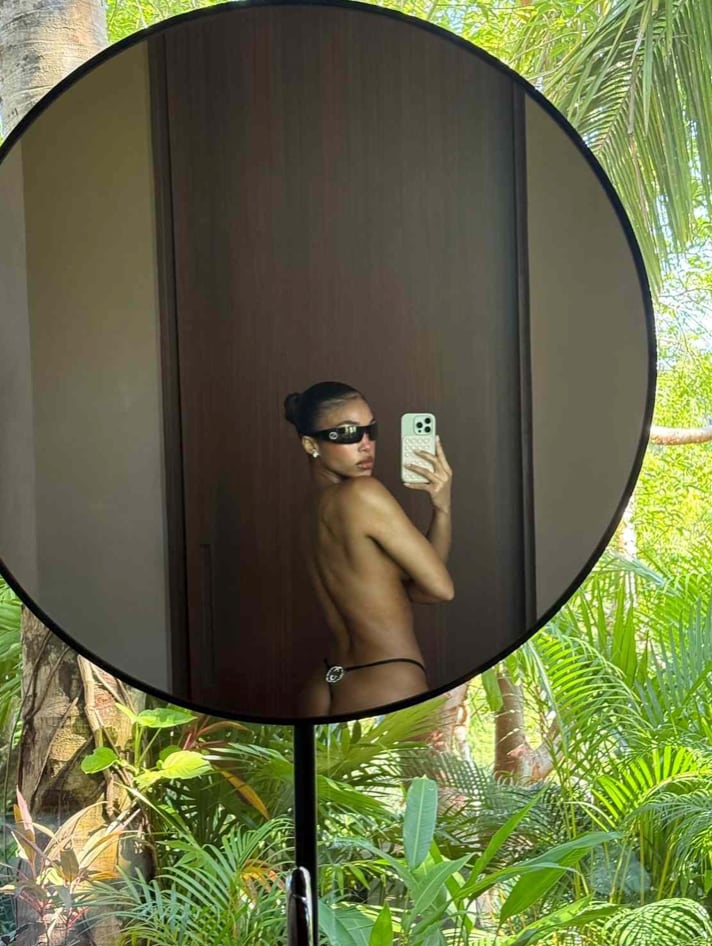 Lori Harvey stunned fans with a topless mirror selfie showcasing a vintage Gucci G-string from Tom Ford’s iconic 1997 spring collection. 