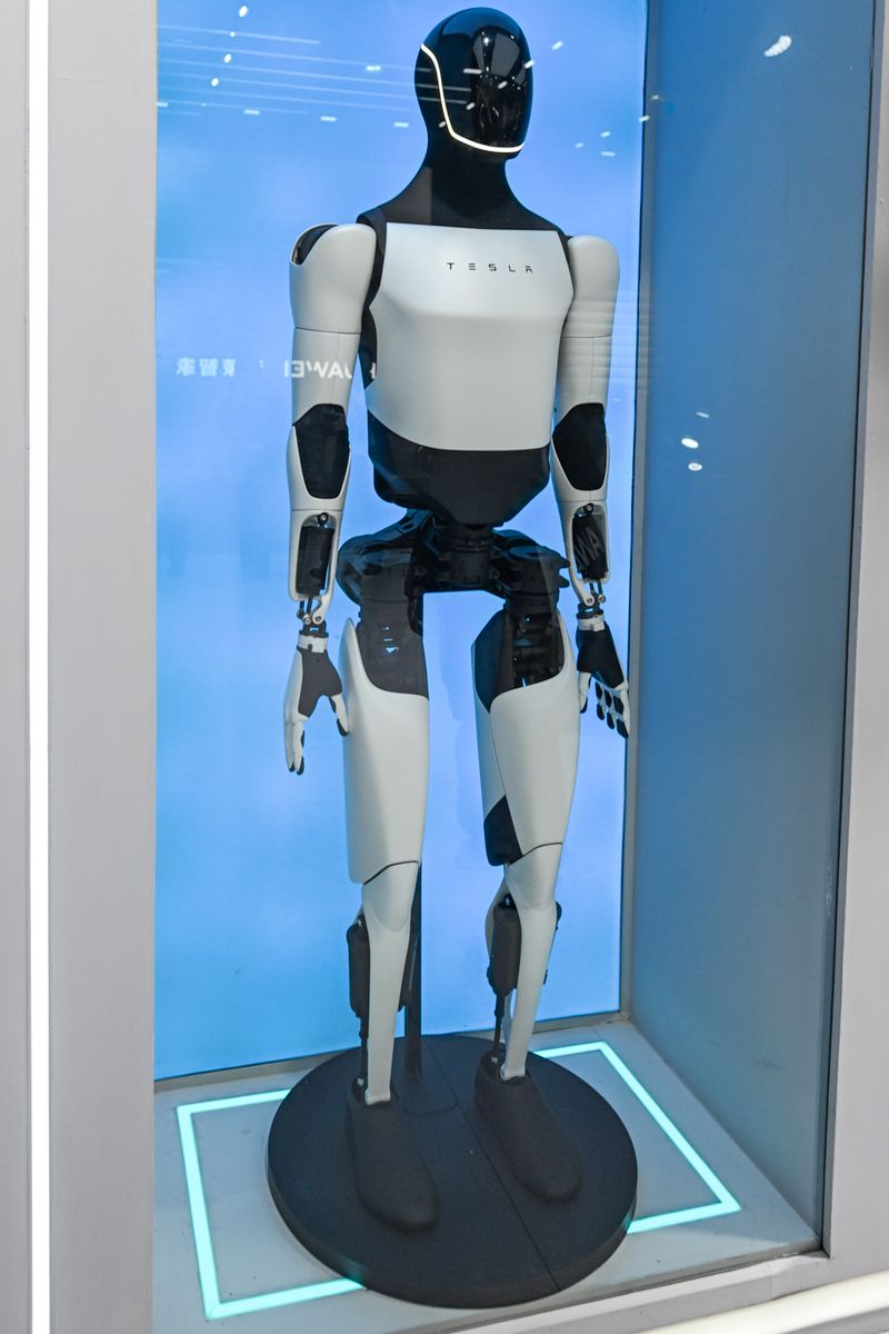 The Tesla Optimus humanoid robot (Tesla Bot) is displayed at the company's booth during the AWE 2026 technology expo, at the Shanghai New International Expo Centre