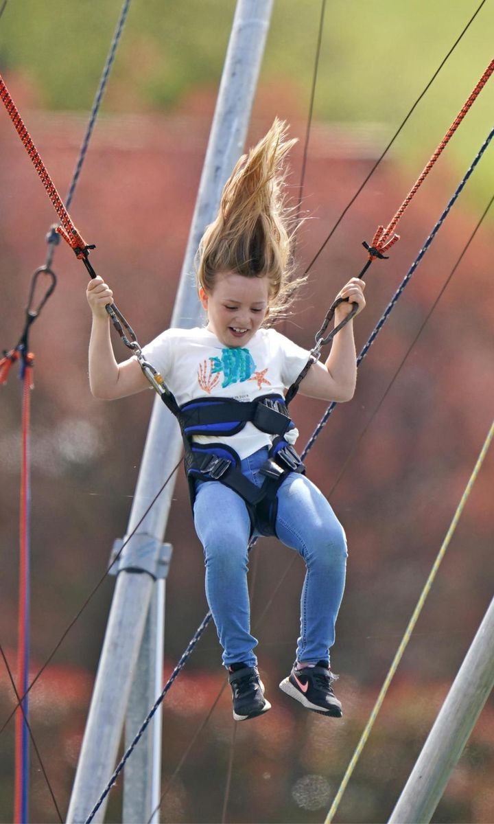 Mia, who is Mike and Zara's eldest child, jumped around on a bungee trampoline.