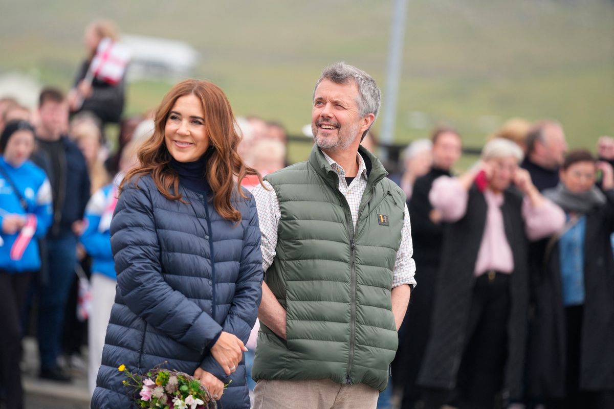 Denmark's King Frederik X and Queen Mary sit on a bench after planting a tree in the plantation in Tvoeroyri on the island of Suduroy in the Faroe Islands, on June 12, 2025. 