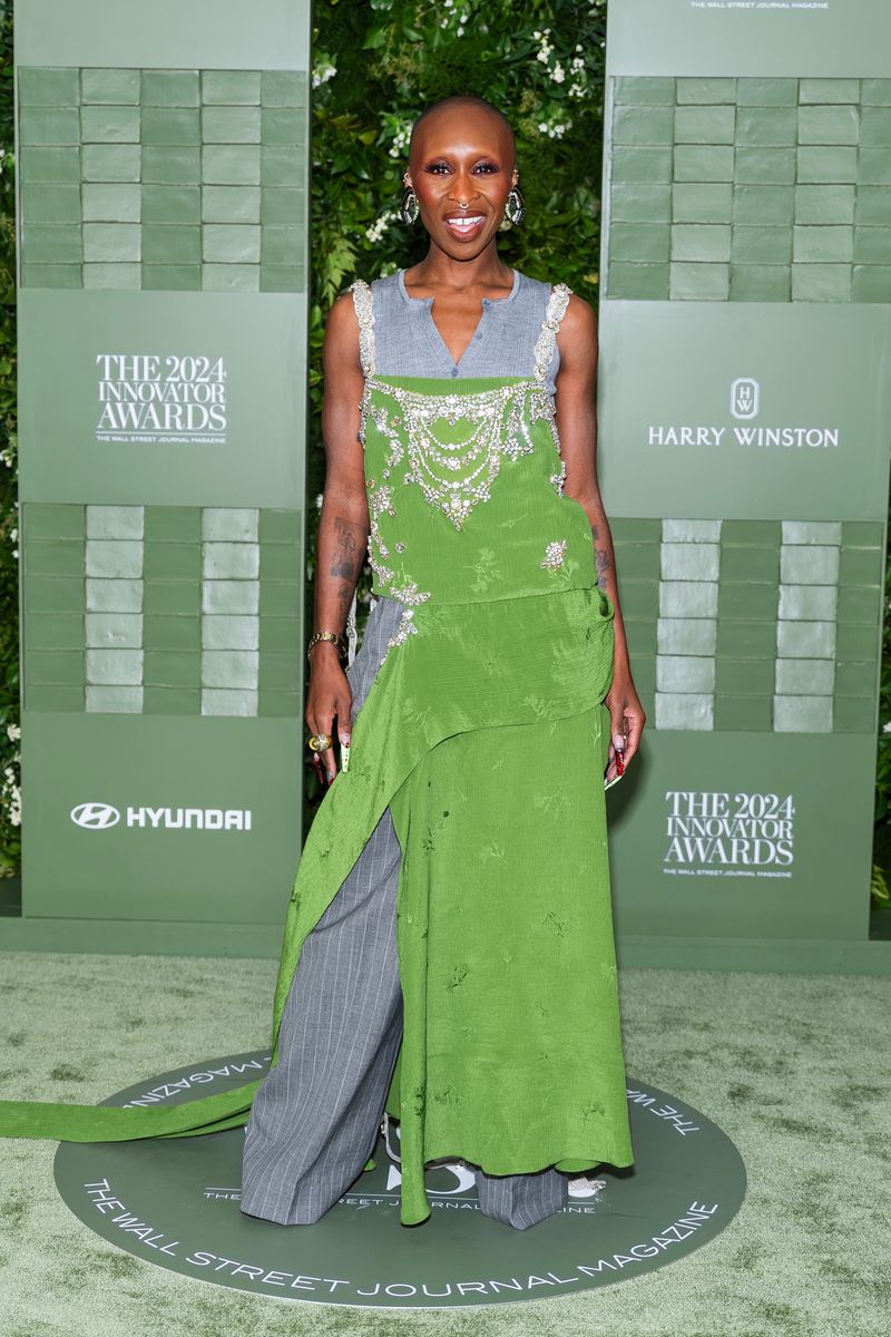 Cynthia Erivo poses on the red carpet wearing the dress-over-pants trend