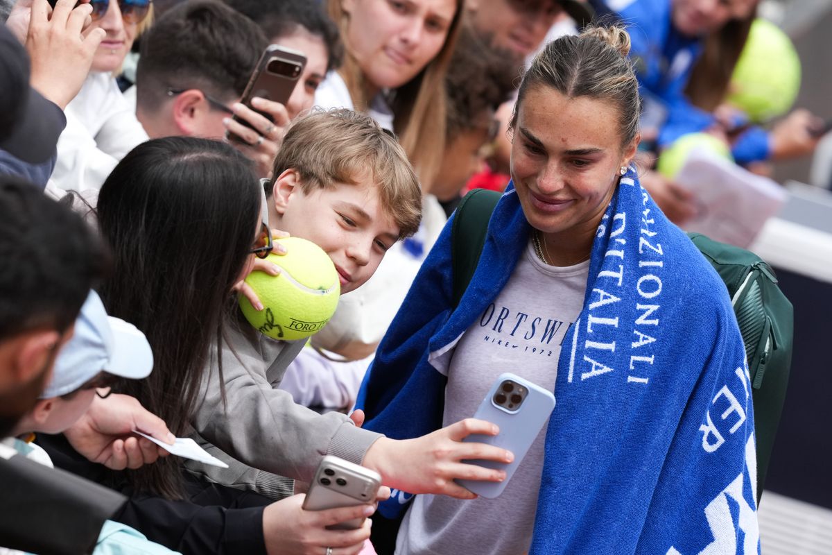 Aryna Sabalenka of Belarus signs autographs and takes pictures at the end of a training session