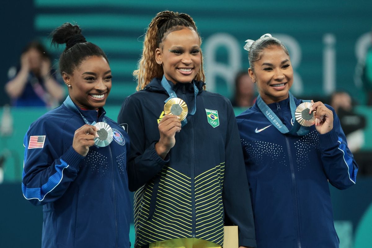 Gold medalist Rebeca Andrade (C) of Team Brazil, silver medalist Simone Biles (L) of Team United States and bronze medalist Jordan Chiles (R) of Team United States pose on the podium at the Artistic Gymnastics Women's Floor Exercise Medal Ceremony on day ten of the Olympic Games Paris 2024 at Bercy Arena on August 05, 2024 in Paris, France. (Photo by Jean Catuffe/Getty Images)