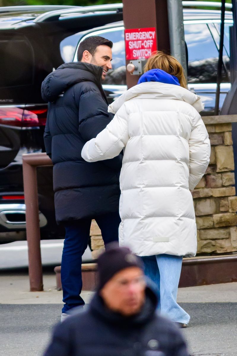 Jennifer Lopez cozies up to co-star Brett Goldstein between takes on the set of her upcoming film "Office Romance" in New Jersey