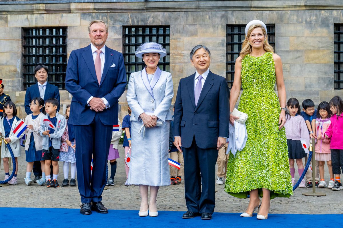 Queen Máxima made a bold fashion statement in a vibrant green floral-appliqué dress as she welcomed Emperor Naruhito and Empress Masako of Japan to Amsterdam.