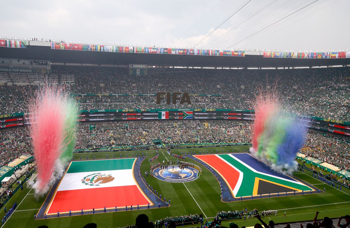 Fireworks and lights illuminate the stadium during the opening ceremony finale.