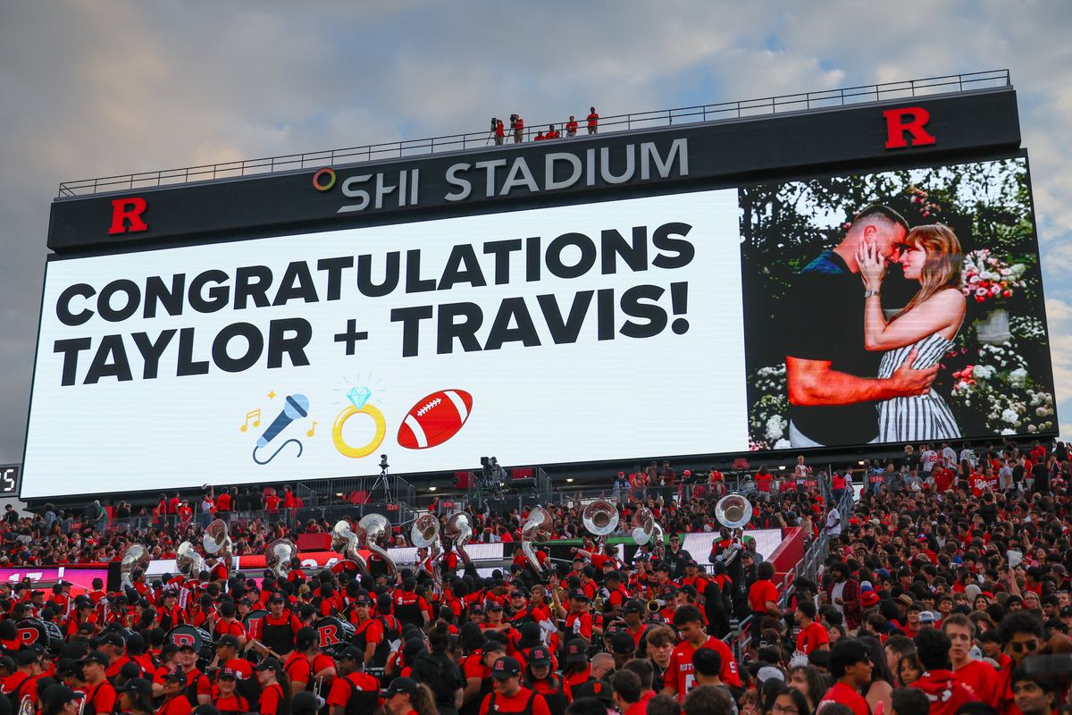The SHI Stadium scoreboard displays a message to Travis Kelce and Taylor Swift after their announcement of their engagement