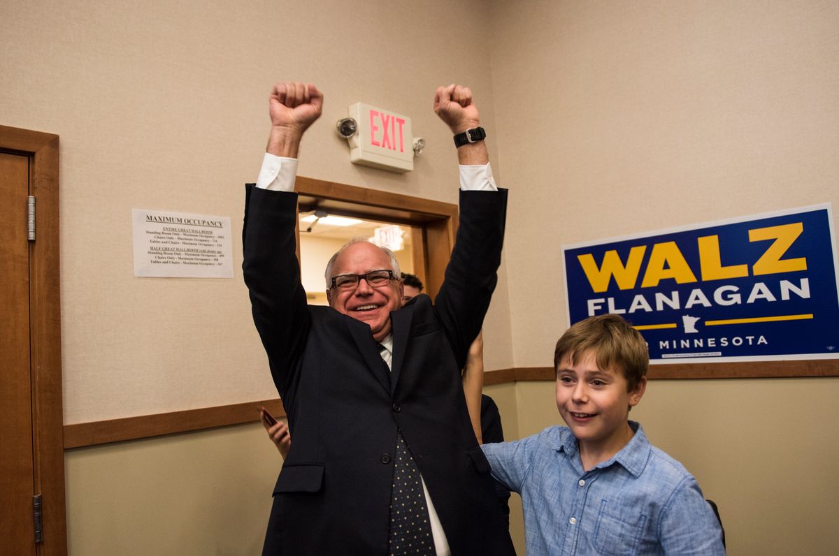  Rep. Tim Walz (D-MN) and his son Gus Walz celebrate while entering his election night party on August 14, 2018, in St Paul, Minnesota. Walz won the night's primary and will be the DFL candidate for Governor in the general election. (Photo by Stephen Maturen/Getty Images)