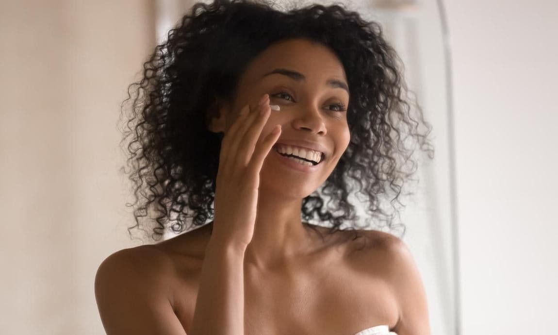 Woman putting on face cream