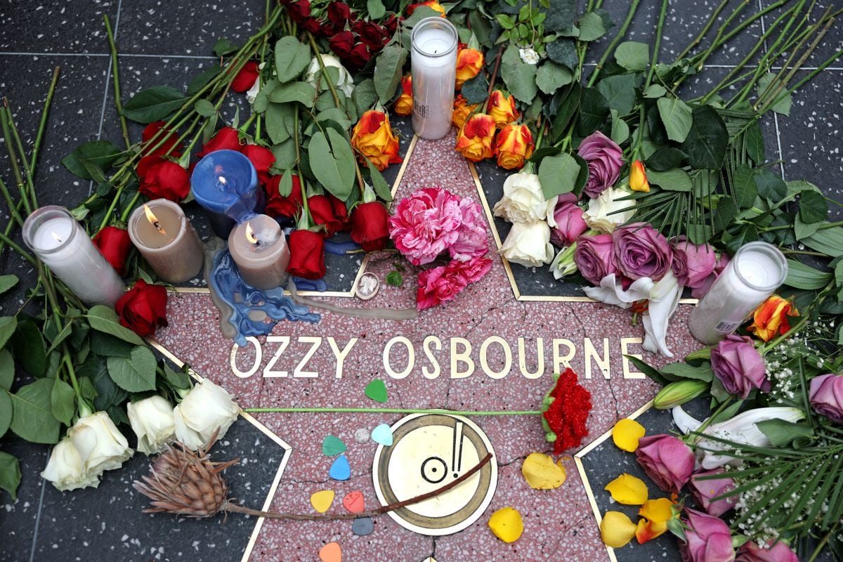 Flowers are left at a makeshift memorial at Ozzy Osbourne's Star on the Hollywood Walk of Fame on July 22, 2025, in Los Angeles.