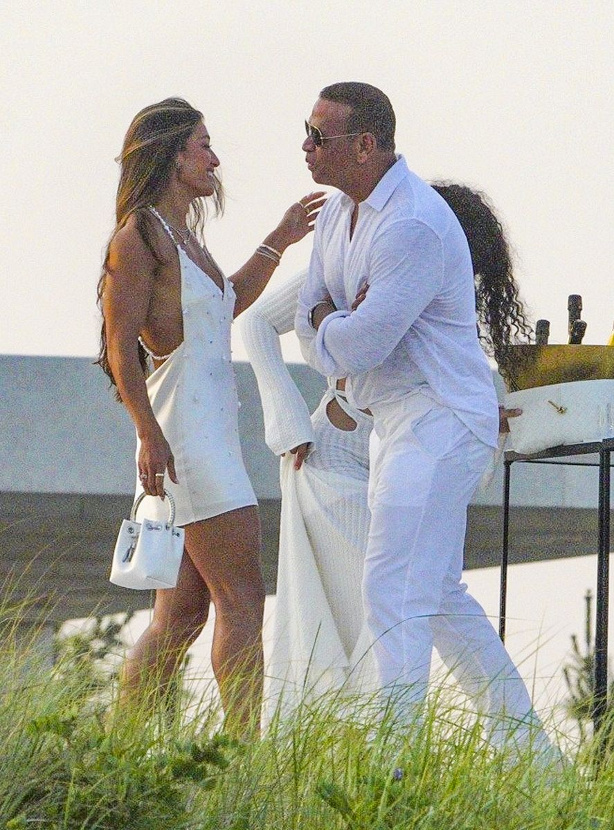 Alex Rodriguez was photographed sharing a kiss with a mystery brunette during Michael Rubin's exclusive White Party in the Hamptons.