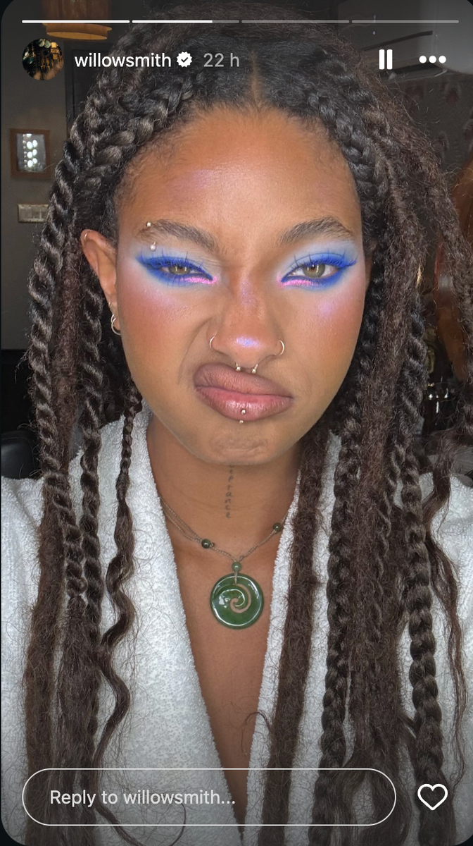 Her complexion features a soft, radiant foundation with a natural finish, lavender and iridescent highlighter across the cheekbones