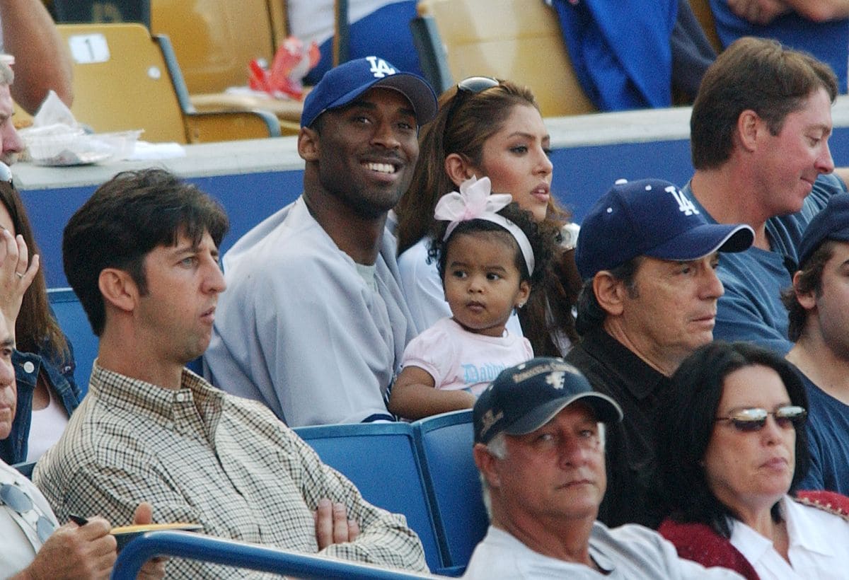 Kobe Bryant sits with Natalia and Vanessa during the Los Angeles Dodgers contest against the New York Yankees at Dodger Stadium, June 20, 2004