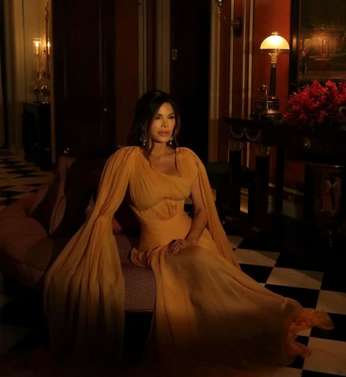 Lauren Sanchez poses in dramatic cape dress and pearl earrings at the  Starlight Ball