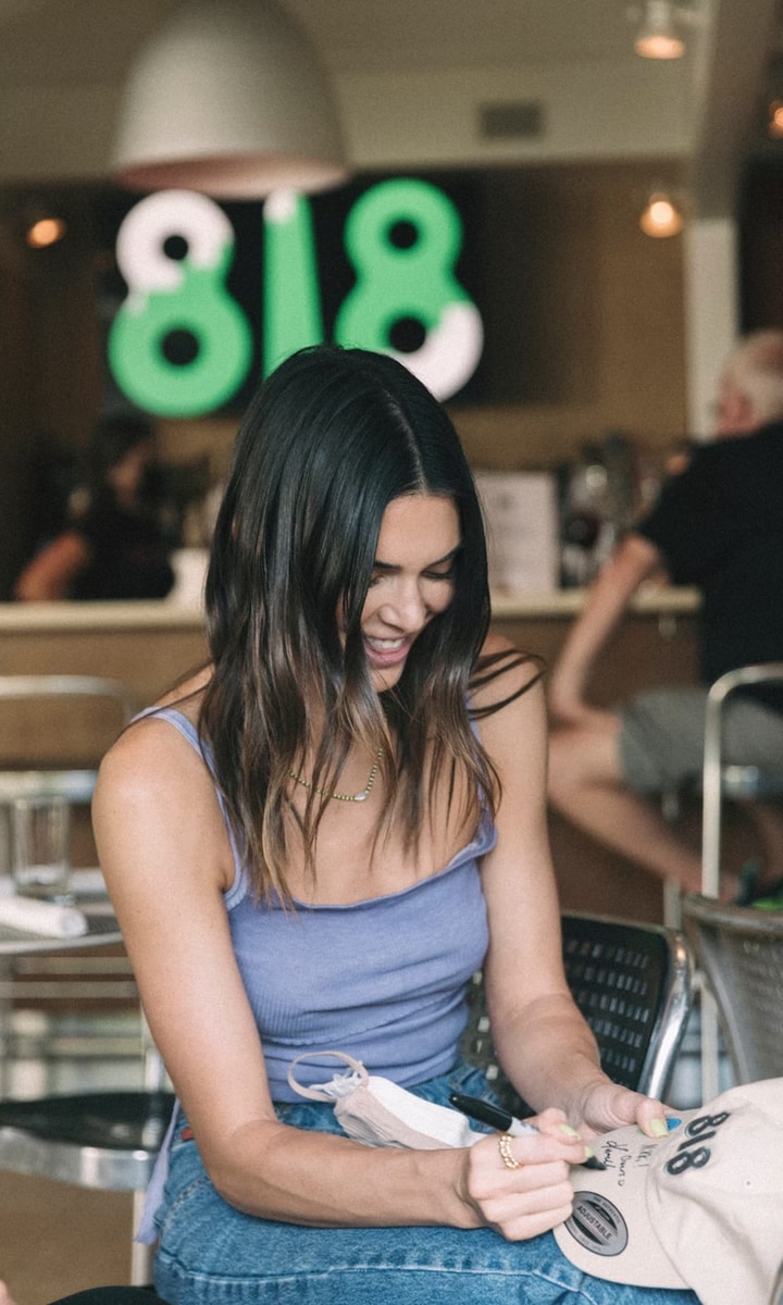 Kendall Jenner is officially a bartender! The businesswoman served her 818 Tequila to fans while visiting the Hamptons