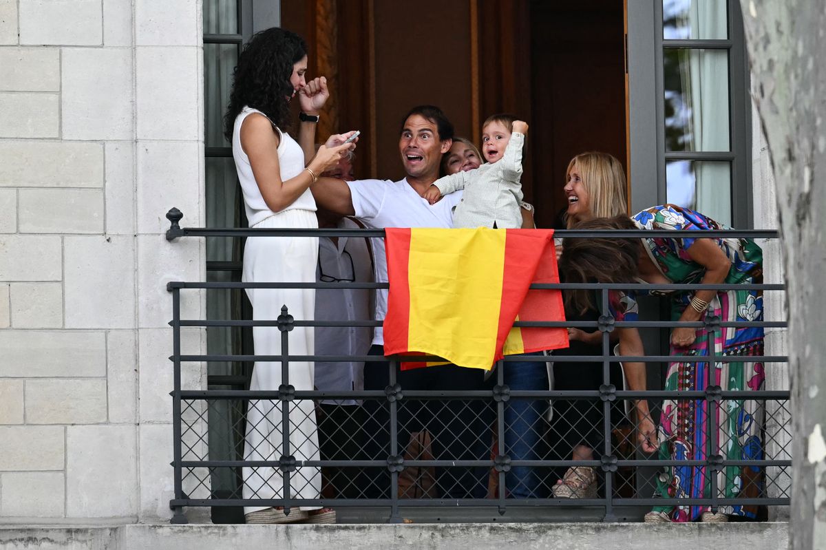 Spain's tennis player Rafael Nadal and his son Rafa Junior react on a balcony during the opening ceremony of the Paris 2024 Olympic Games in Paris on July 26, 2024.