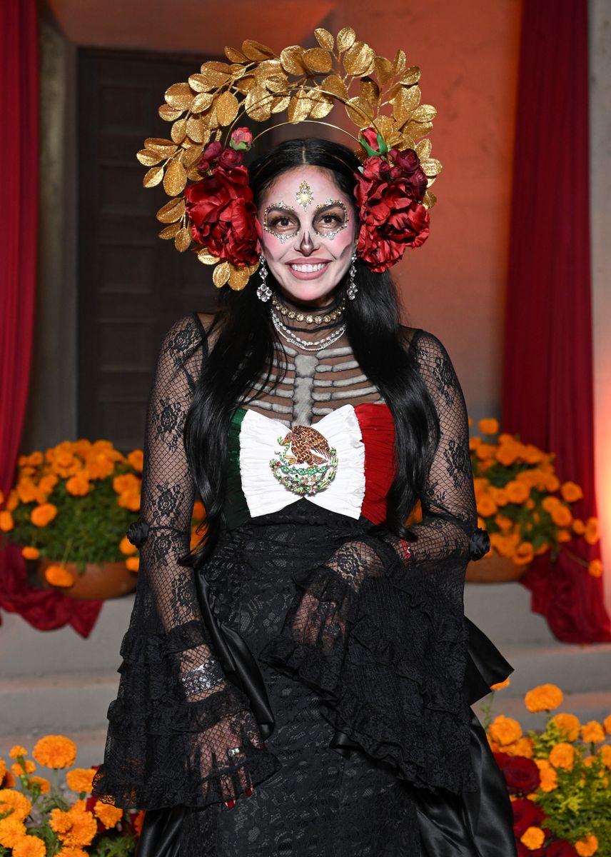 Her eyes were surrounded by sparkling crystals arranged in circular patterns, creating the signature hollow-eyed appearance associated with La Catrina