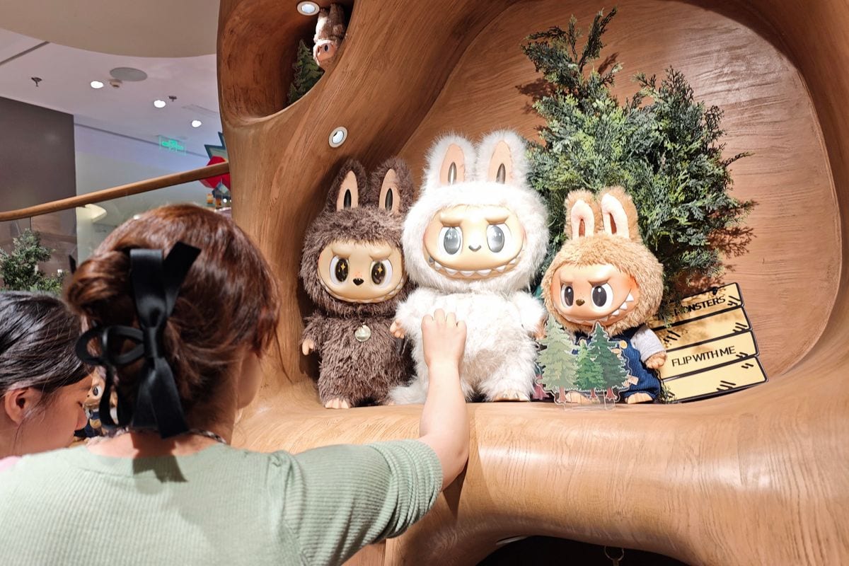 A customer looks at Labubu figures at a Pop Mart store in Shanghai on June 11, 2025. A Beijing auction house has sold a four-foot-tall sculpture of a viral plush toy character for more than $150,000, as global demand for the Chinese-designed Labubu dolls reaches fever pitch. (Photo by AFP) / China OUT (Photo by STR/AFP via Getty Images)          