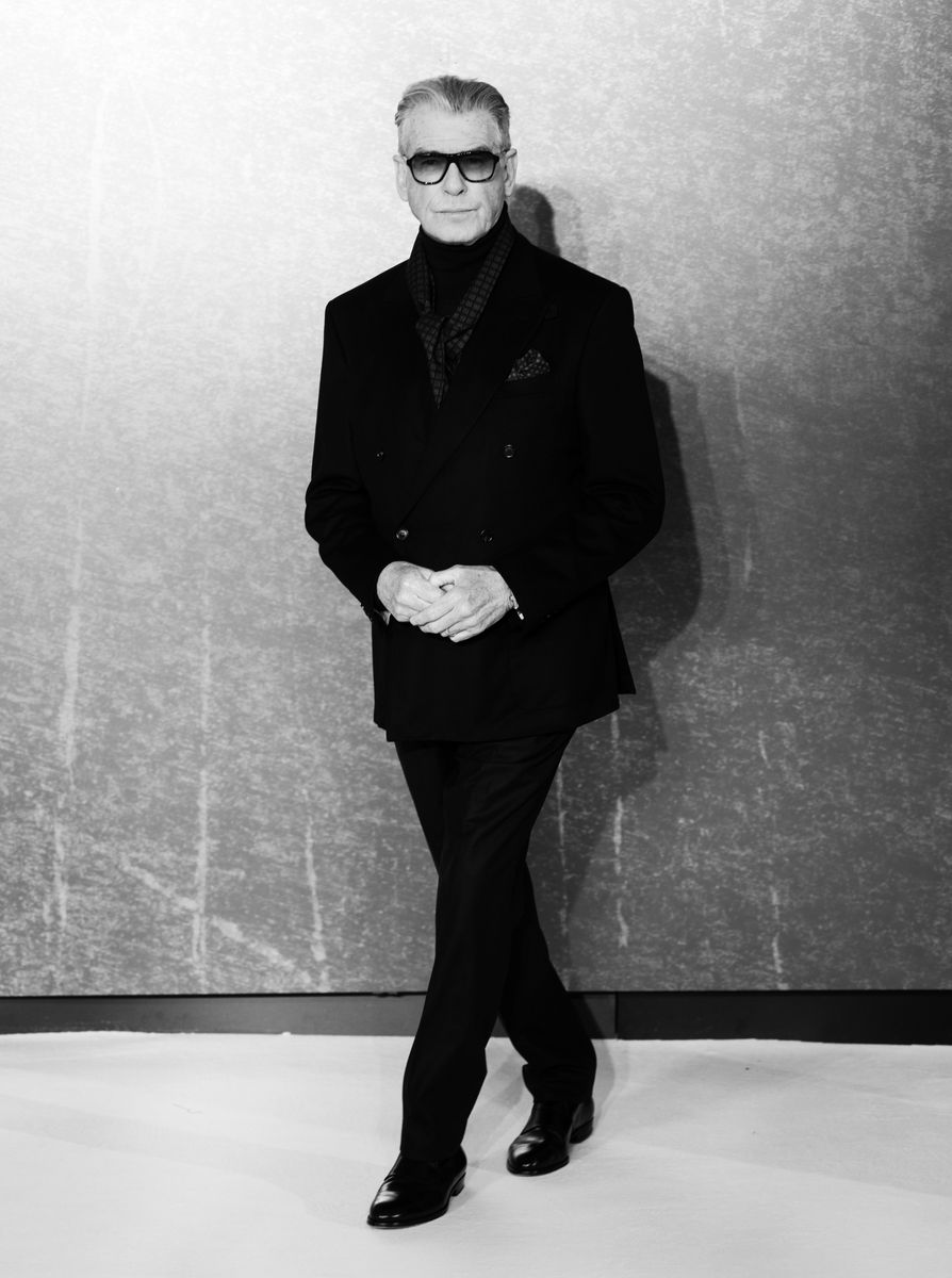 In the black-and-white photo, Pierce Brosnan exudes timeless sophistication.