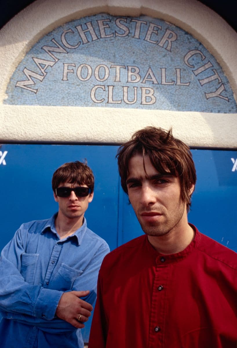 Noel and Liam Gallagher of British rock band Oasis outside Maine Road stadium, Manchester, 2 August 1994