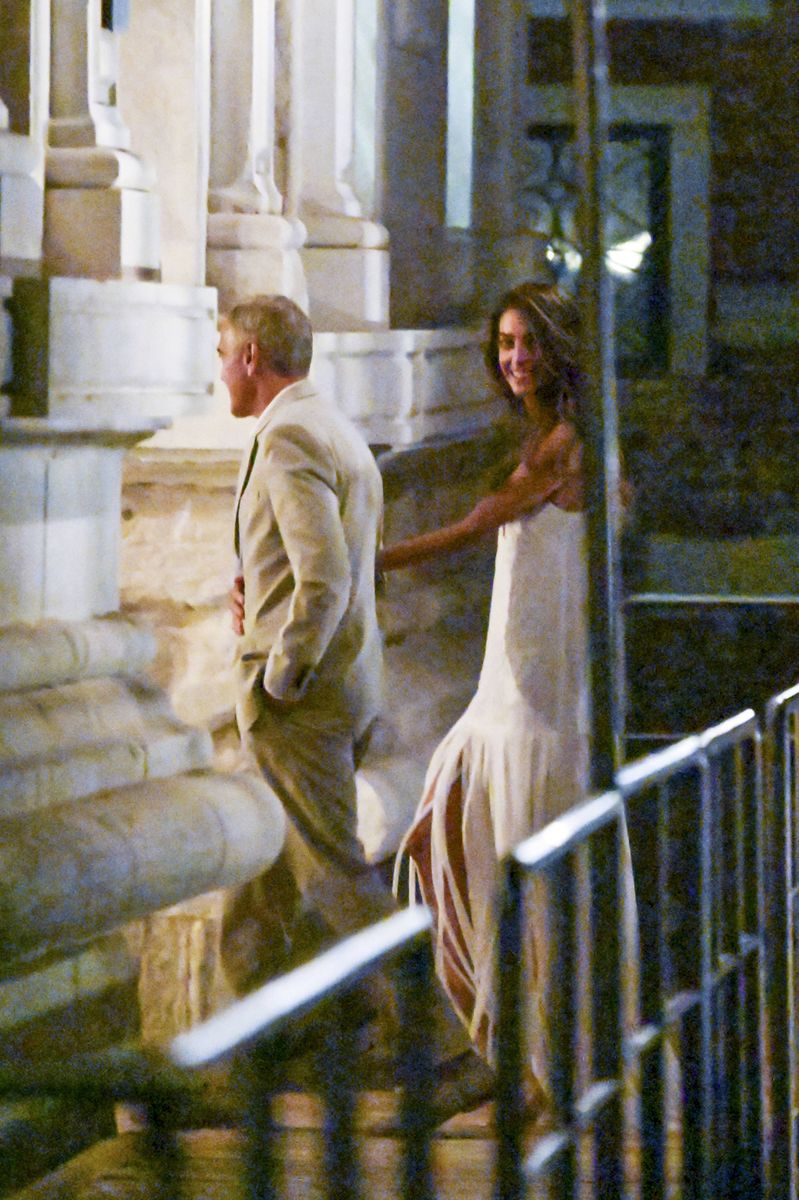 George looked elegant in a light gray suit, open-collar white shirt and beige suede loafers.