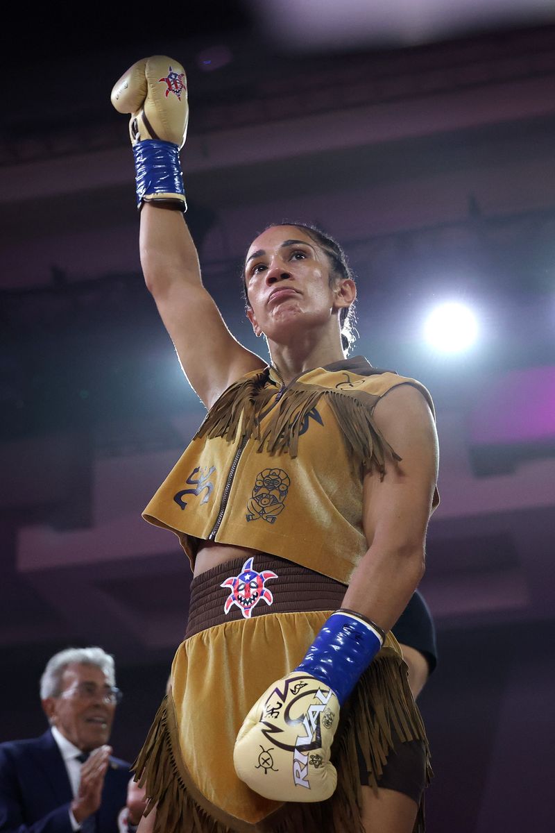 Serrano earned professional victory No. 50 in August 2026, defeating Argentina’s Lucrecia Manzur while retaining her featherweight titles.
