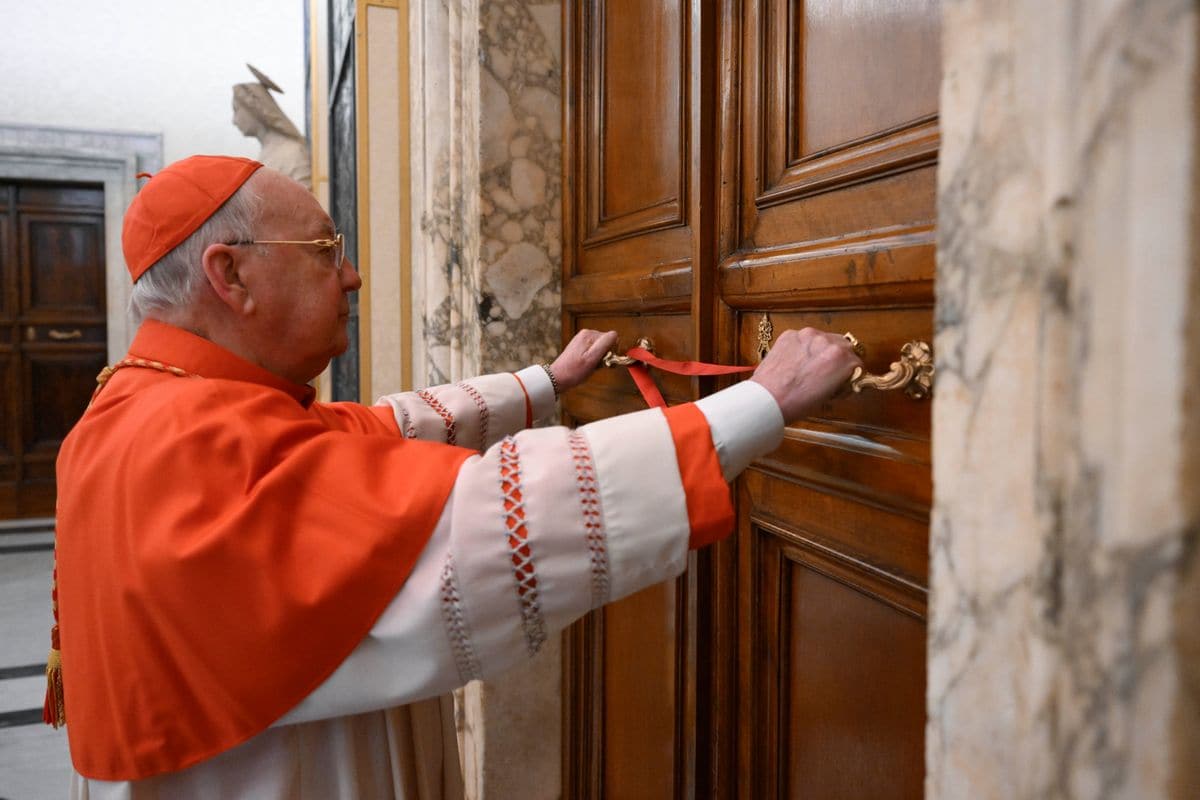 Cardinal Kevin Farrell (C), Camerlengo of the Apostolic Chamber, puts seals on the Papal apartment of the Apostolic Palace on April 21, 2025 in Vatican City, Vatican. 