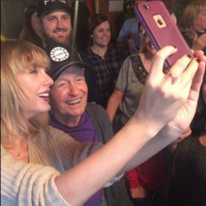 Taylor surprised her oldest fan and made it a Christmas to remember! The <i>Blank Space</i> singer surprised WWII veteran Cyrus Porter, 96, at his home in New Madrid, Missouri, with a performance inside of his home for him and his family.
Cyrus' grandson Robert shared several photos of Taylor posing for selfies, performing for guests and even getting a tour of Cyrus' memorabilia.
Robert shared a collage of photos from his grandpa's big day on Twitter with the sweet caption, "Taking selfies, holding babies, hugging grandpas and leaving lipstick marks. Taylor Swift does it all. Awesome day for my Popo!!"
Photo: Twitter/@@bert_frye