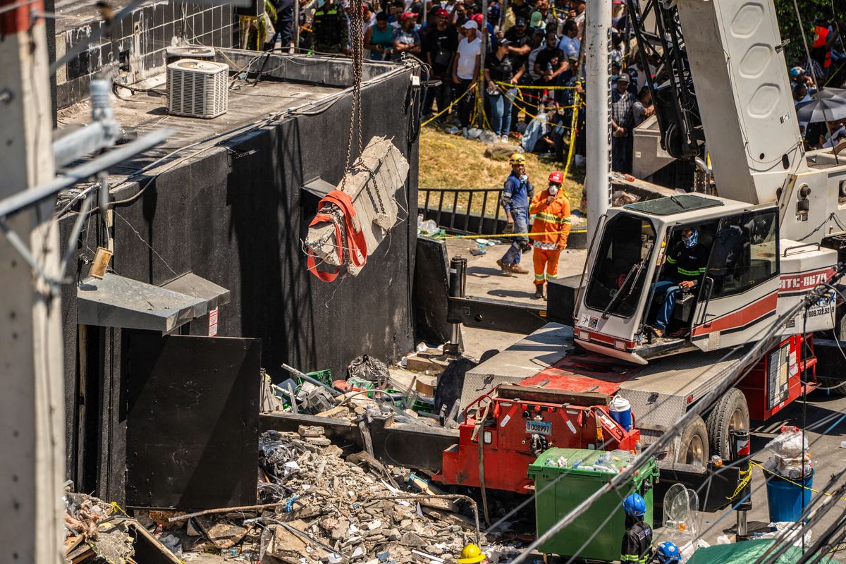 Personnel from civil defense and firefighters work at the Jet Set nightclub following the collapse of its roof in Santo Domingo on April 8, 2025. 