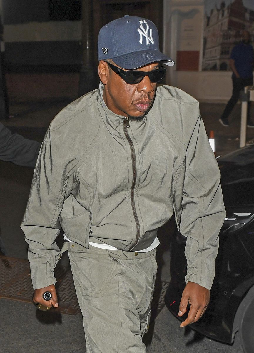 Jay-Z arrived separately for his wife's birthday celebration, opting for a relaxed monochromatic look with a New York Yankees cap and dark sunglasses.