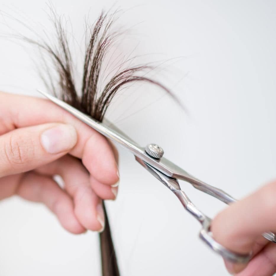 Scissors trimming a lock of hairn