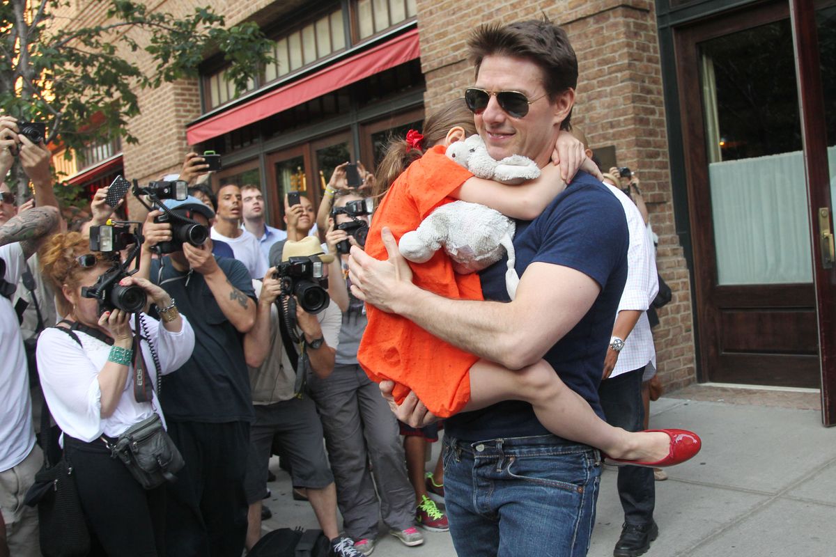 Tom Cruise leaves his hotel carrying daughter Suri for her gymnastics class on July 17, 2012 in New York, NY.