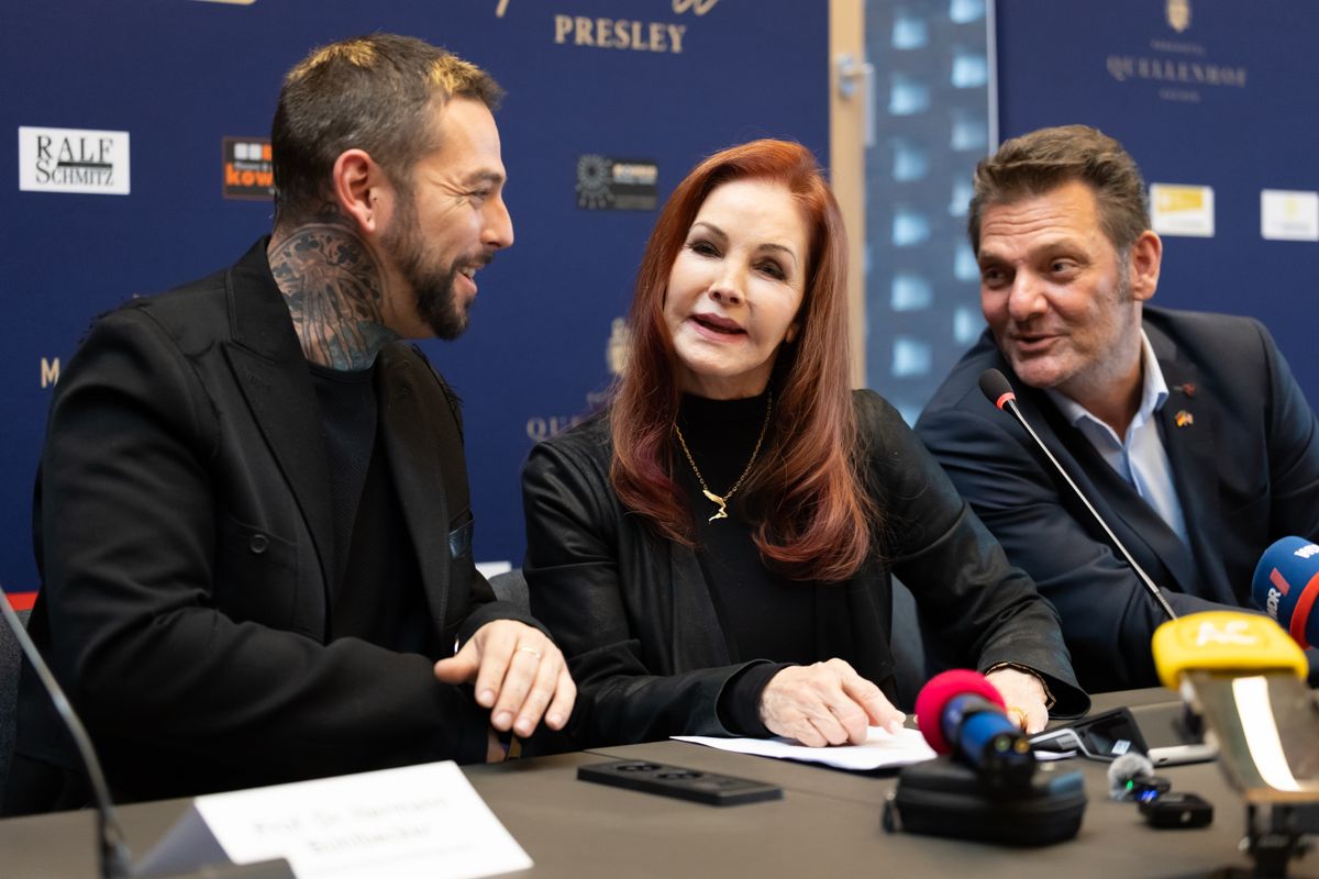 BAESWEILER, GERMANY - OCTOBER 20: Priscilla Presley with her son Navarone Garibaldi Garcia and Detlef Malinkewitz (R) attend a visit to Baesweiler on October 20, 2026 in Baesweiler, G. ermany. (Photo by Andreas Rentz/Getty Images)