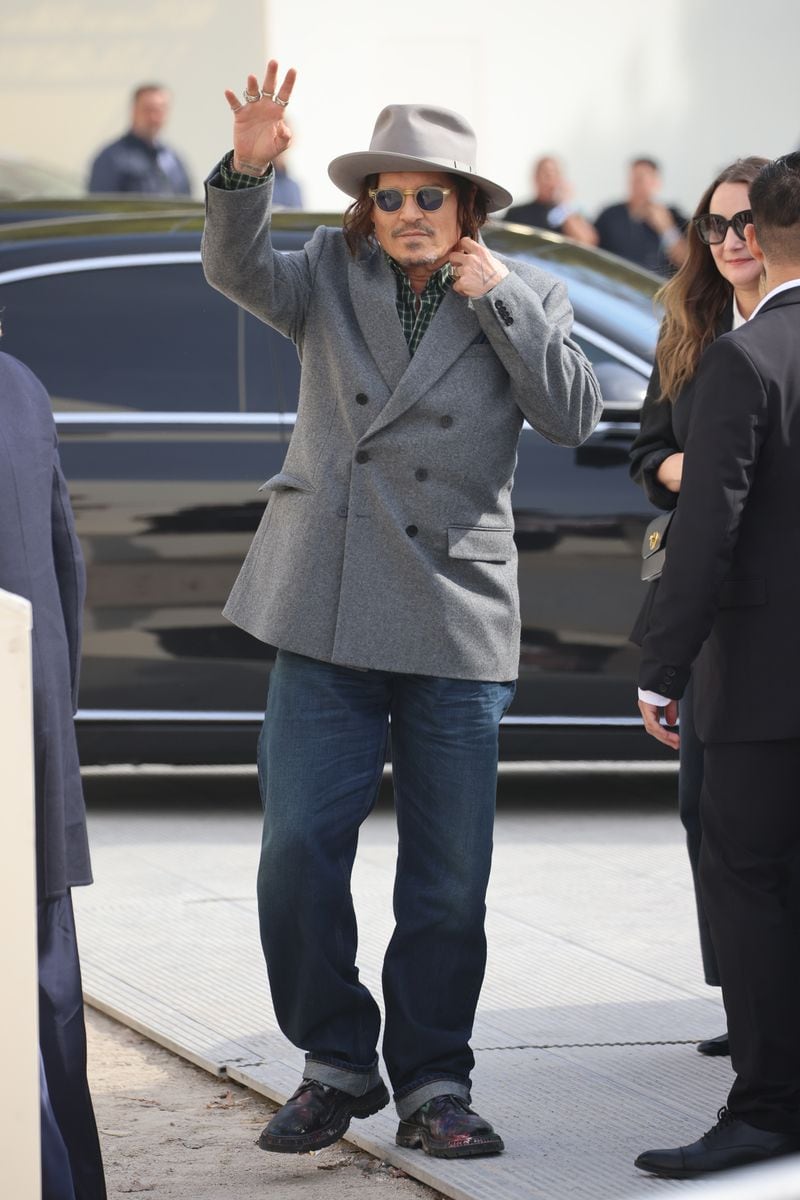 Johnny Depp was left lingering uncomfortably behind the group