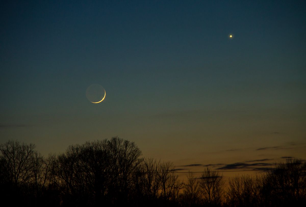 A conjunction of the planets and the moon in a twilight winter sky