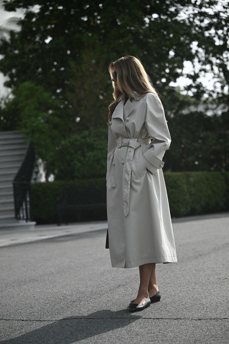 First Lady Melania Trump listens as US President Donald Trump speaks as they depart from the South Lawn of the White House in Washington, DC, on April 25, 2025, en route to Joint Base Andrews. The president and first lady are traveling to Rome to attend the funeral of Pope Francis. (Photo by Brendan SMIALOWSKI / AFP) (Photo by BRENDAN SMIALOWSKI/AFP via Getty Images)          