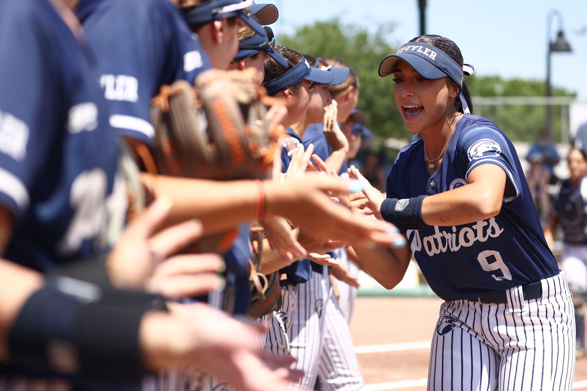 Makayla Garcia #9 of the UT Tyler Patriots high fives teammates during player introductions before the Division II Womens Softball Championship against the Western Washington Vikings held at Boombah-Soldiers Creek Park on May 25, 2024 in Longwood, Florida. (Photo by Tyler Schank/NCAA Photos via Getty Images)