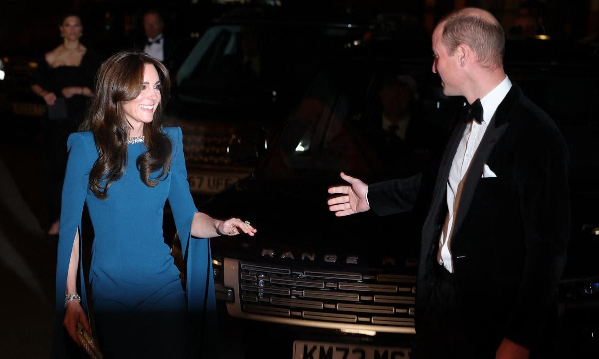 William sweetly reached for his wife's hand, while an individual could be heard in a video shouting about Omid Scobie's Endgame book and Piers Morgan's show.