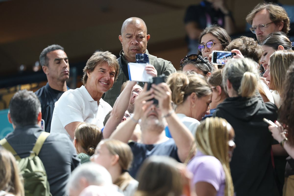 American actor Tom Cruise interacts with fans on the stands during the Artistic Gymnastics Women's Qualification match on day 2 of the Paris 2024 Olympic Games at Bercy Arena on July 28, 2024, in Paris, France. (Photo by Sheng Jiapeng/China News Service/VCG via Getty Images)